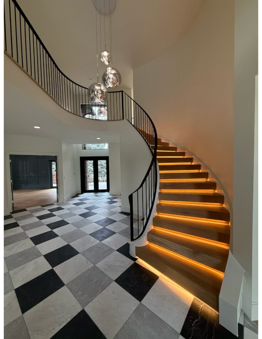 Modern foyer with spiral staircase and checkered floor.