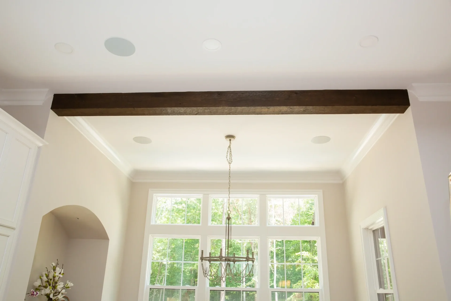 Elegant room with large windows and chandelier.